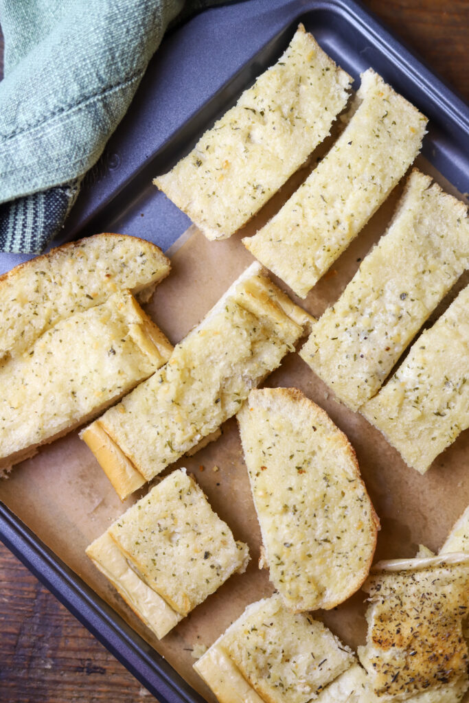 You've got to make this quick and easy garlic bread. It's the best two ingredient garlic bread. All you're going to need is an Italian loaf from the bakery of your grocery store and Land O Lakes garlic and herb spread. If you need a quick garlic bread for any meal, this is it. It's so delicious.