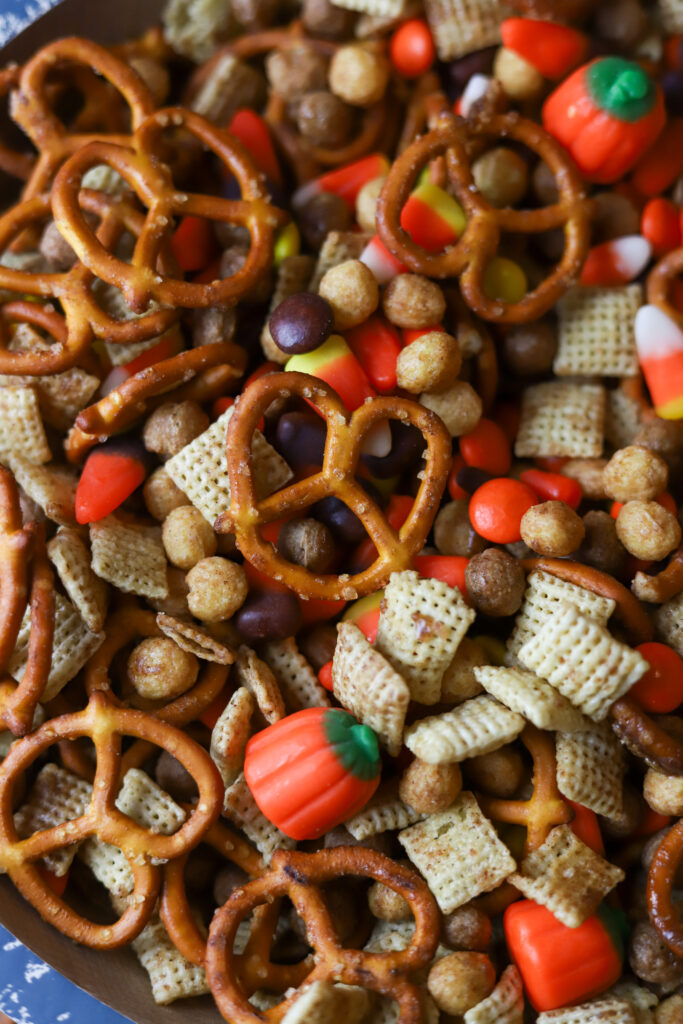 I am in love with this Halloween Chex mix recipe. It has the sweetness and the salty components with my personal favorite, candy corn! This mix is tossed and slow baked in a very generous amount of melted butter with brown sugar, cinnamon, and maple extract. I just want to tell you; this Halloween snack mix is addicting. I keep this on hand season, and it's so easy to make! You could even hand it out as little trick or treat goodie bags! 