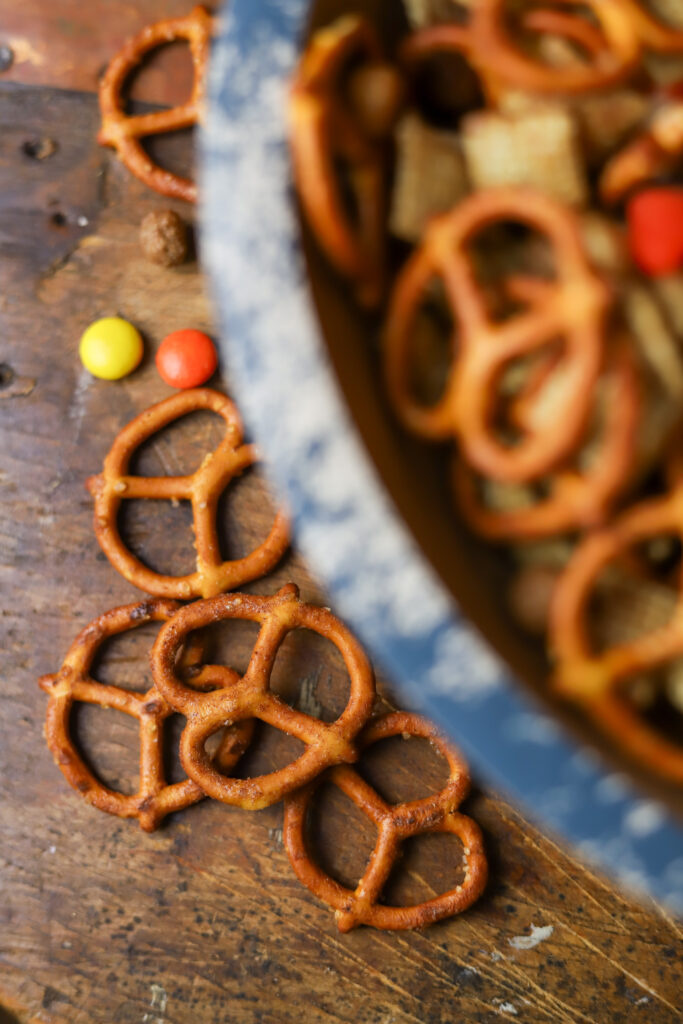 I am in love with this Halloween Chex mix recipe. It has the sweetness and the salty components with my personal favorite, candy corn! This mix is tossed and slow baked in a very generous amount of melted butter with brown sugar, cinnamon, and maple extract. I just want to tell you; this Halloween snack mix is addicting. I keep this on hand season, and it's so easy to make! You could even hand it out as little trick or treat goodie bags! 