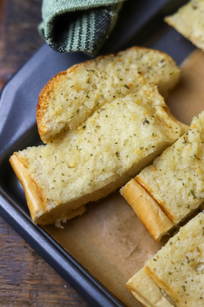 You've got to make this quick and easy garlic bread. It's the best two ingredient garlic bread. All you're going to need is an Italian loaf from the bakery of your grocery store and Land O Lakes garlic and herb spread. If you need a quick garlic bread for any meal, this is it. It's so delicious.