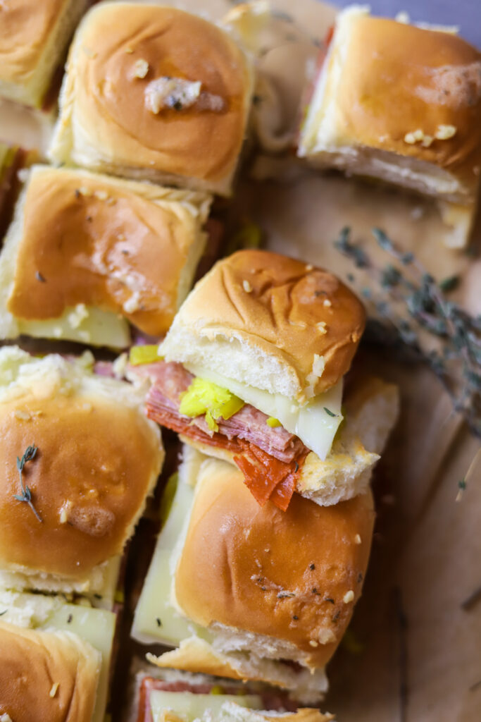 I love this hot Italian sliders recipe. You can make a meal out of these or make them as an appetizer. These are simple. They’re just pepperoni, salami, provolone and banana peppers in some Hawaiian rolls. You’ll love these; I promise.