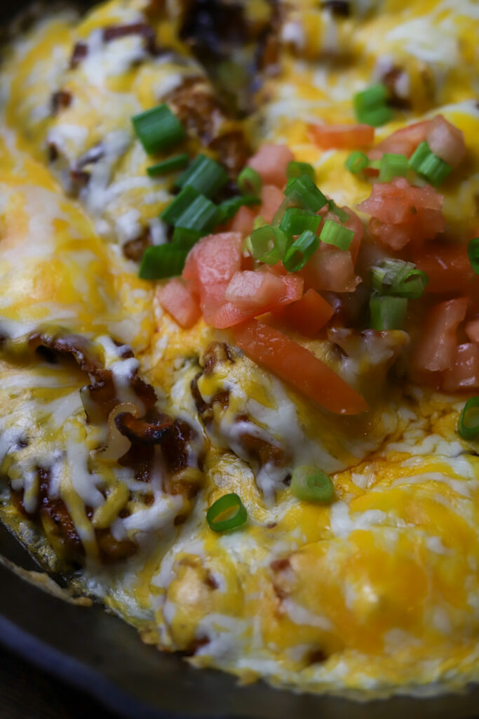 This Monterey chicken skillet is a perfect dinner idea. It's a pan-fried chicken breast, smothered in barbeque sauce, baked and them topped with a blend of cheese and bacon. This is really taking a simple chicken breast and kicking it up a notch. This easy dinner is something different that's packed with flavor.