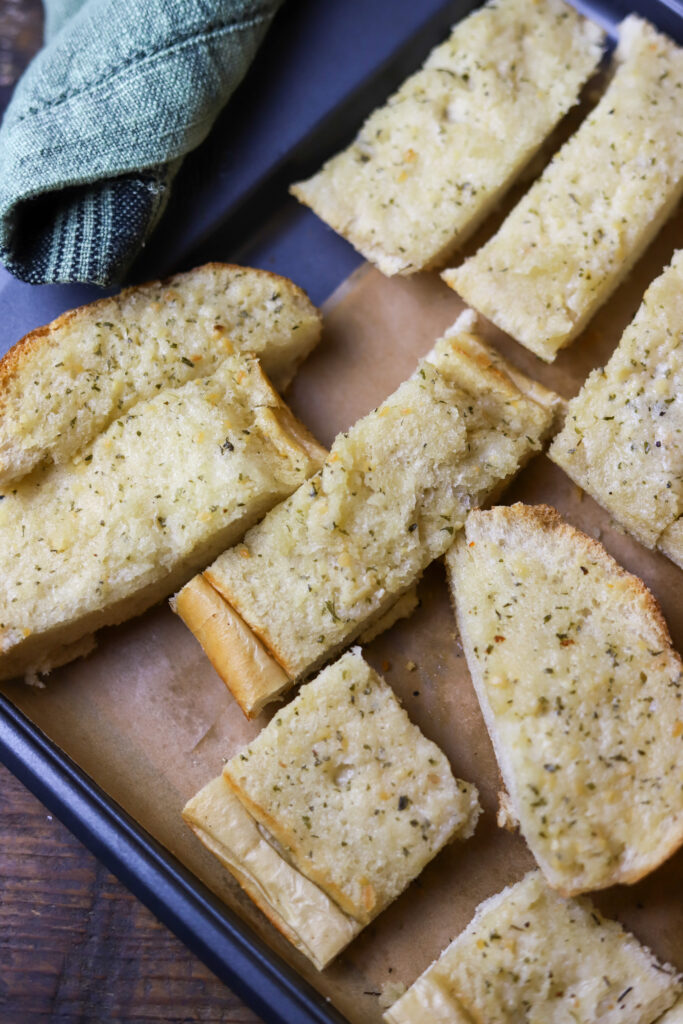 You've got to make this quick and easy garlic bread. It's the best two ingredient garlic bread. All you're going to need is an Italian loaf from the bakery of your grocery store and Land O Lakes garlic and herb spread. If you need a quick garlic bread for any meal, this is it. It's so delicious.