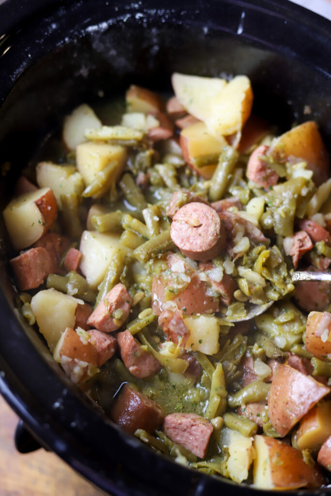 This slow cooker ranch sausage potatoes and green beans recipe is the easiest dinner. You have it all. Meat, potatoes and a vegetable. Literally, throw all the ingredients in your crockpot and let them cook on high for at least 5 hours. This is the simplest, no-brainer meal.