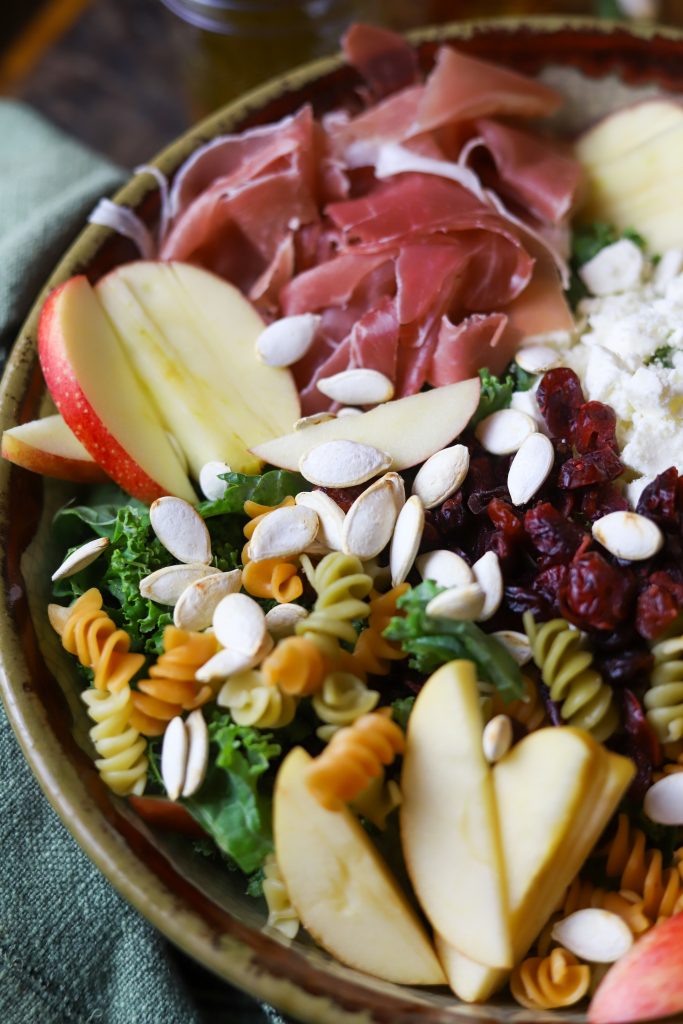 Enjoy a burst of autumn flavors with this fall pasta salad, packed with pastas, apples, savory prosciutto and feta, crunchy seeds and a sweet maple dressing.